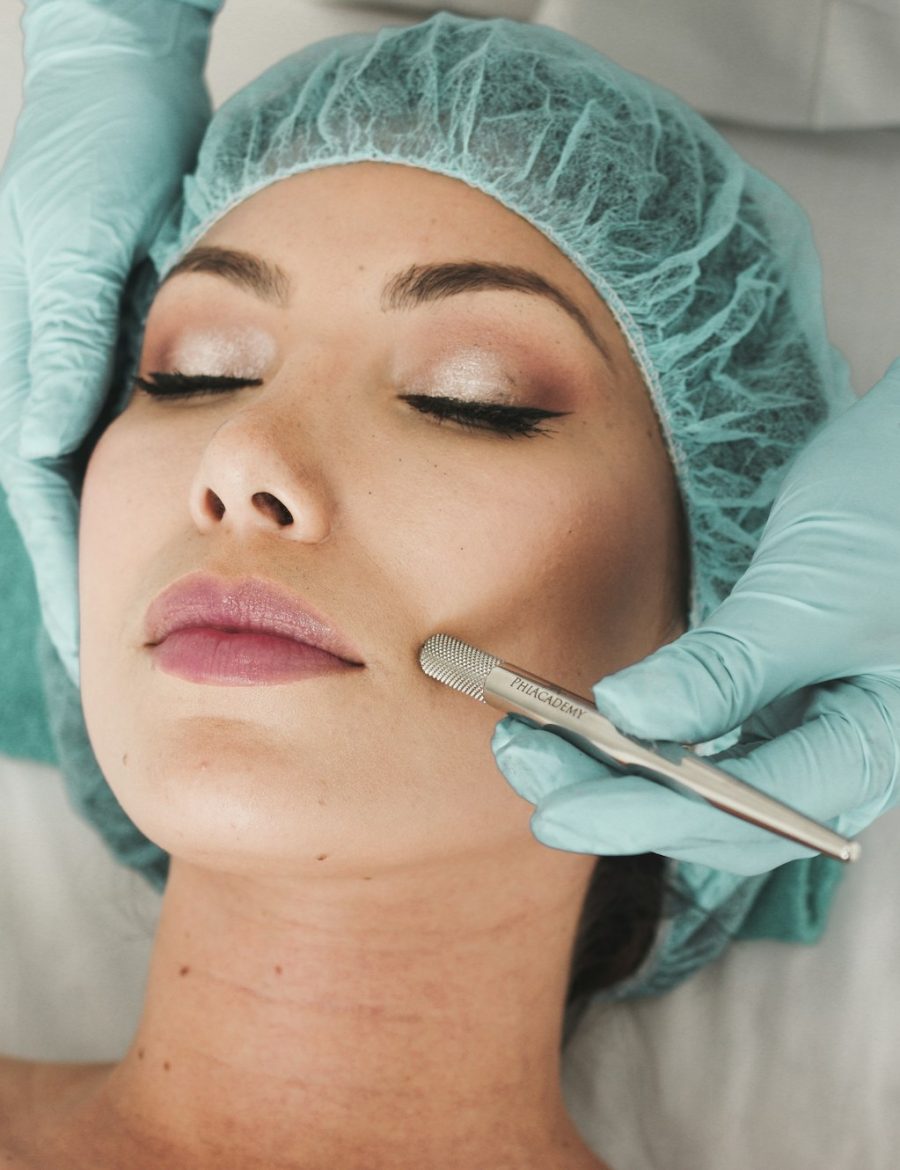 A practitioner working across a patient's cheek during a no-downtime laser session