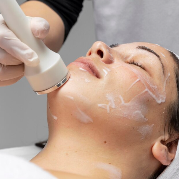 A focused-ultrasound HIFU handpiece during a non-surgical face lifting session