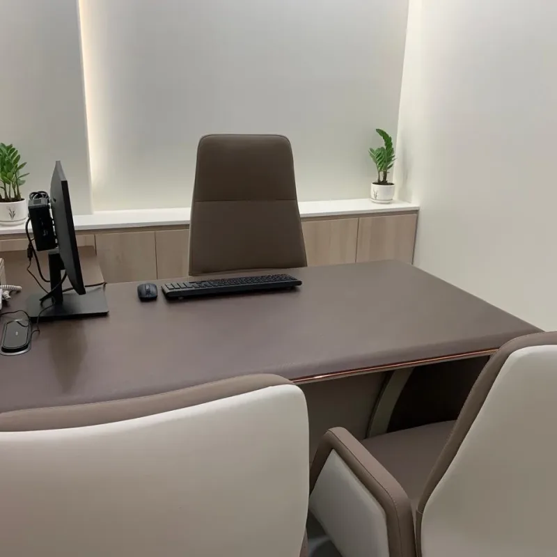 Consultation room at Veloura Clinic Gurgaon with a doctor’s desk and two patient chairs
