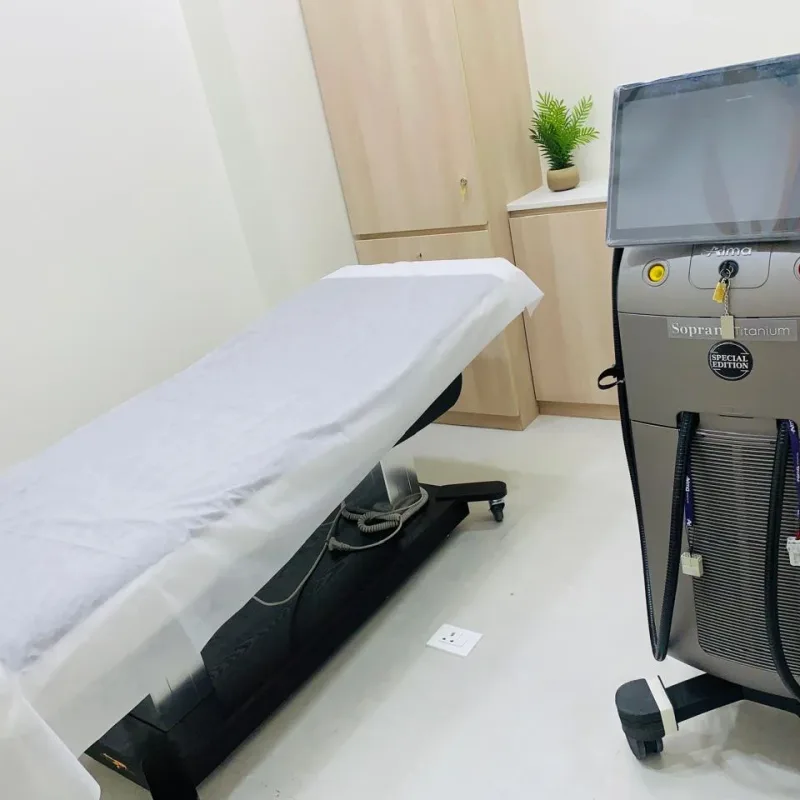 Laser hair reduction room at Veloura Clinic Gurgaon with a Soprano Titanium laser and treatment bed