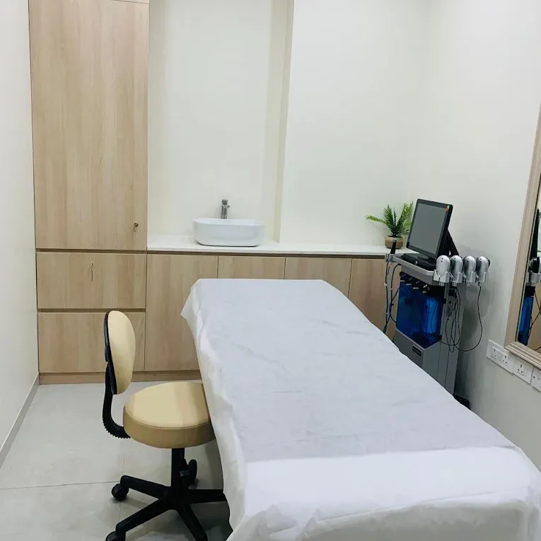 Skin treatment room at Veloura Clinic Gurgaon with a treatment bed and a facial treatment machine
