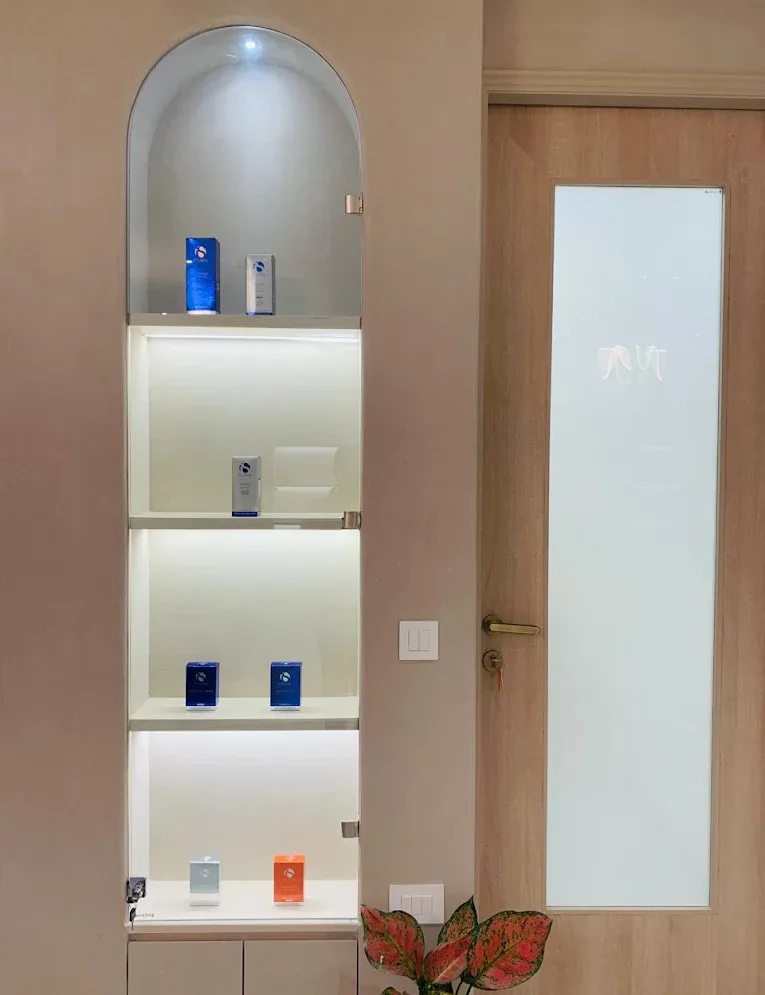 Skincare products on a lit display niche inside Veloura Clinic, Gurgaon