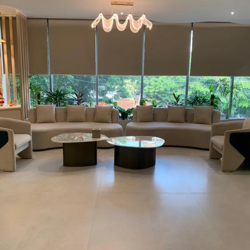 Veloura Clinic Gurgaon waiting lounge with curved sofas, marble coffee tables and large windows